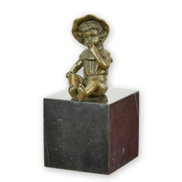 A BRONZE SCULPTURE OF A LITTLE GIRL SITTING