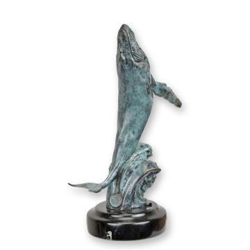 A BRONZE SCULPTURE OF A BREACHING HUMPBACK WHALE