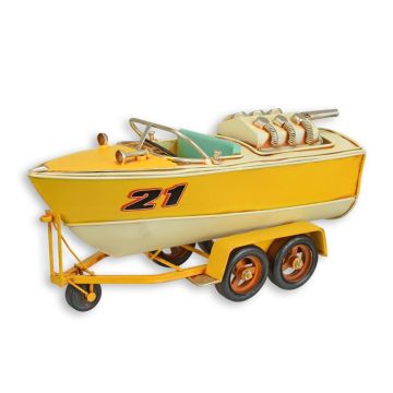 A TIN MODEL OF A SPEEDBOAT ON TRAILER