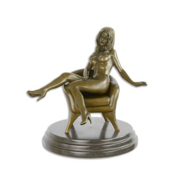 AN EROTIC BRONZE SCULPTURE OF A SEATED FEMALE NUDE