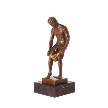 A BRONZE SCULPTURE OF A MALE NUDE