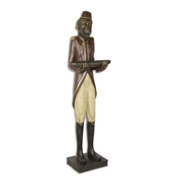 A RESIN FIGURINE OF A MONKEY BUTTLER