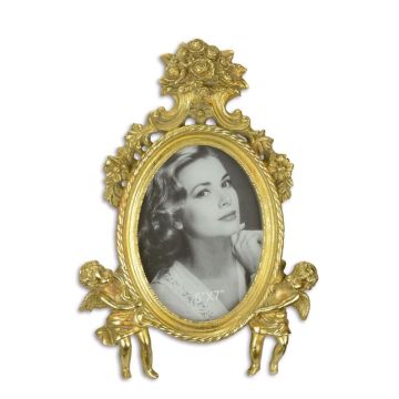 A RESIN PHOTO FRAME FLANKED BY TWO PUTTI