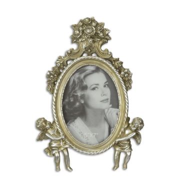 A RESIN PHOTO FRAME FLANKED BY TWO PUTTI