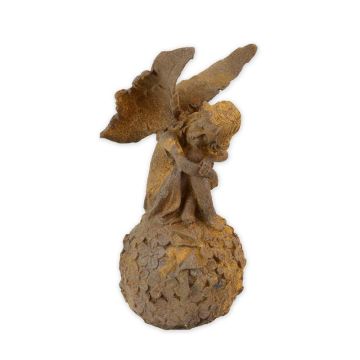 A RUSTY CAST IRON FIGURINE OF A FAIRY ON BALL