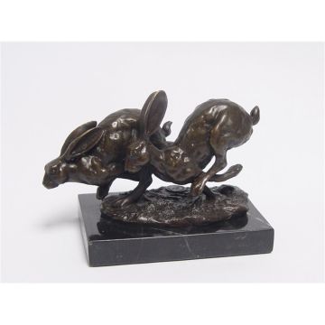 A BRONZE SCULPTURE OF TWO RUNNING HARES