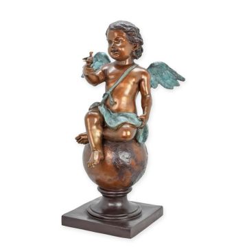 A BRONZE SCULPTURE CUPID SITTING ON BALL WITH BIRD