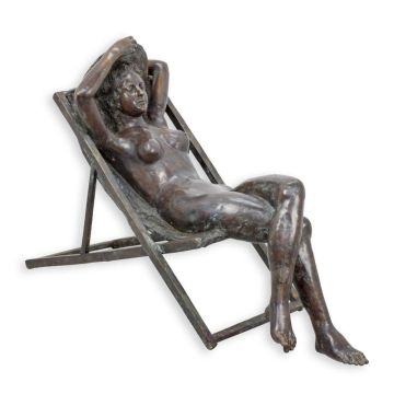 A BRONZE SCULPTURE OF A LADY ON A DECK-CHAIR