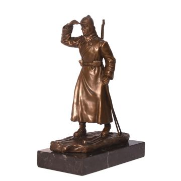 A BRONZE SCULPTURE OF A RUSSIAN SOLDIER ON SKIES