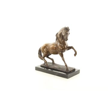A BRONZE SCULPTURE OF A STALLION