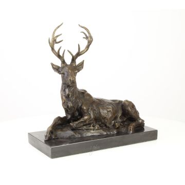 A BRONZE SCULPTURE OF A RECLINING DEER
